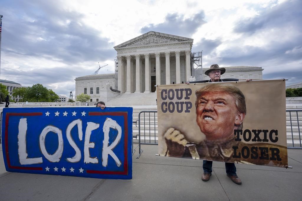 The Latest: Justices fire questions at Trump's lawyer as Supreme Court arguments start