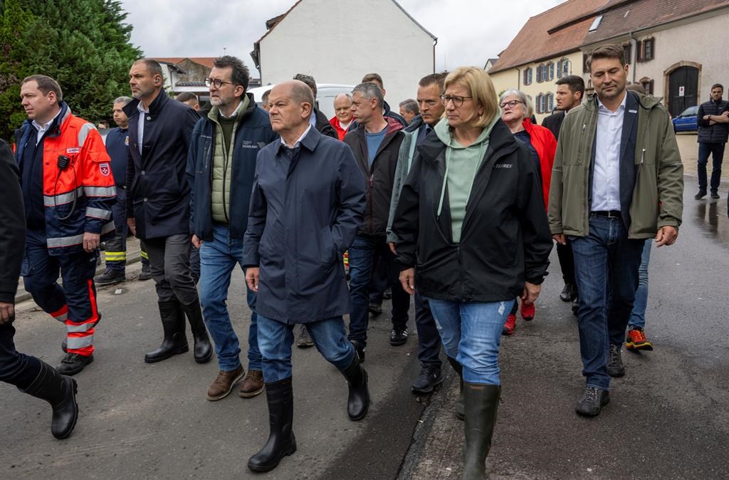 The German chancellor tours flooded regions in the southwest in a show of solidarity