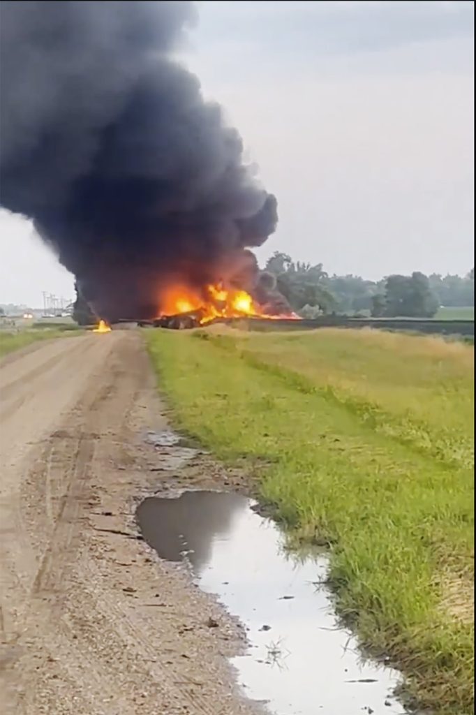 Fiery railcars with hazardous material mostly contained after derailment in North Dakota