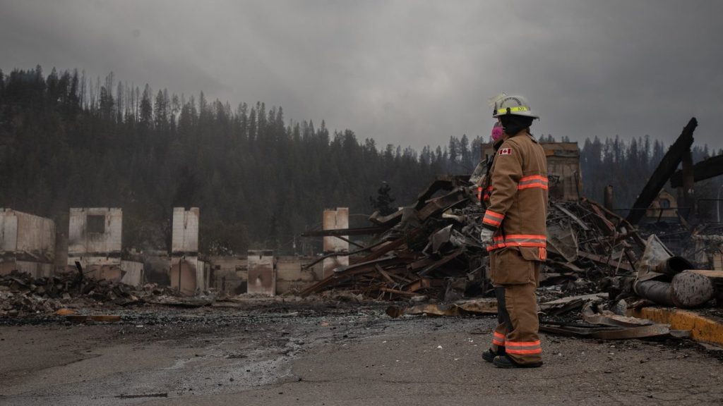 Fire crews work to put out hot spots in the Maligne Lodge in Jasper, Alta., on July 26, 2024. THE CANADIAN PRESS/Amber Bracken