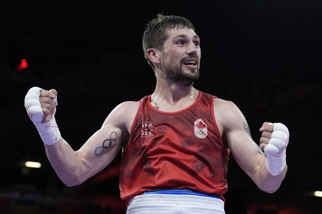 Canada's Wyatt Sanford, celebrates after defeating Uzbekistan's Ruslan Abdullaev in their men's 63.5kg quarterfinal boxing match at the 2024 Summer Olympics, Thursday, Aug. 1, 2024, in Paris, France.