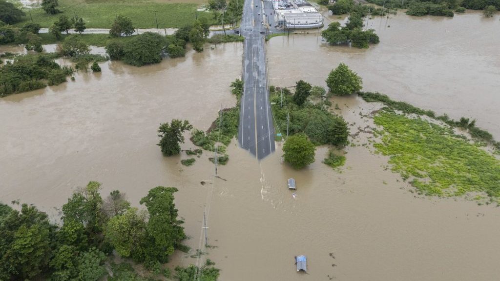 La Plata river floods a road after Tropical Storm Ernesto passed through Toa Baja, Puerto Rico, Wednesday, Aug. 14, 2024. (AP Photo/Alejandro Granadillo)