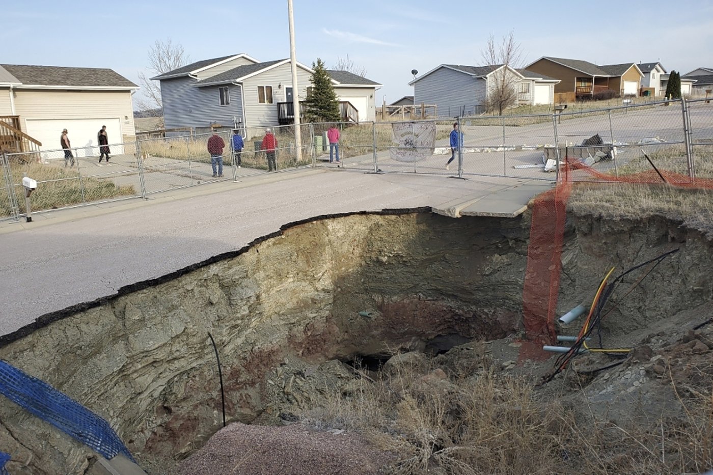 Giant sinkholes in a South Dakota neighborhood make families fear