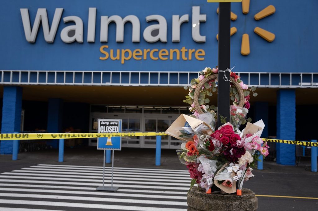 A Walmart remains closed as a vigil grows 