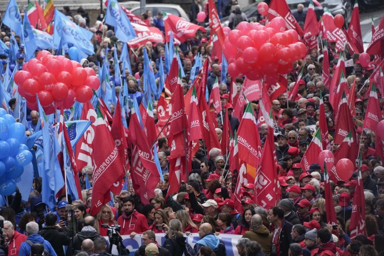 Thousands of workers march across Italy in general strike demanding