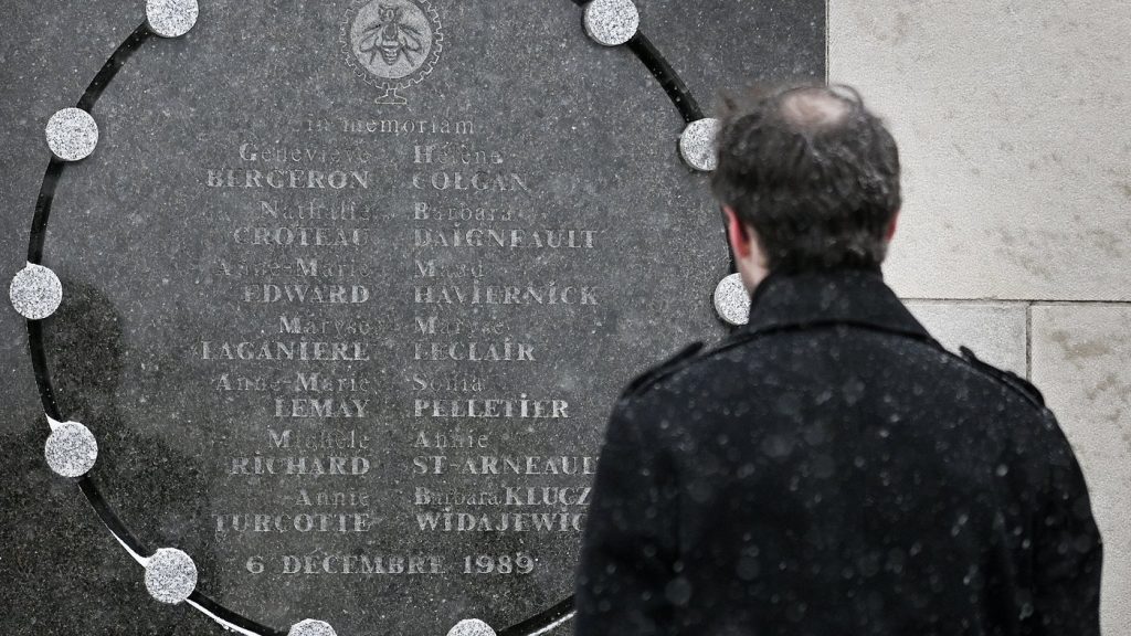 A person stands next to a memorial plaque for the victims of the 1989 Ecole Polytechnique massacre in Montreal, Saturday, Dec. 6, 2025. Today marks the 36th anniversary of the shooting by an anti-feminist that left 14 women dead and 13 others injured. THE CANADIAN PRESS/Graham Hughes