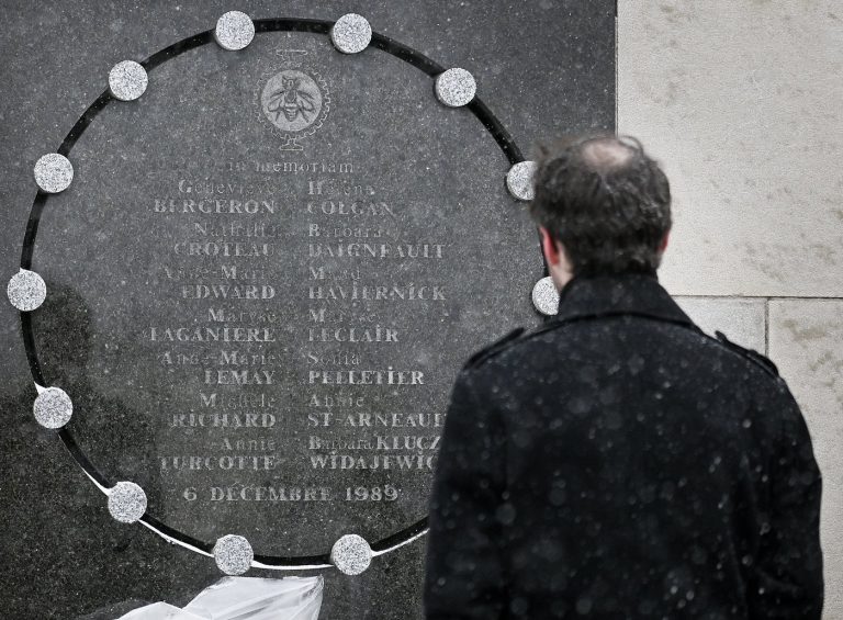 A person stands next to a memorial plaque for the victims of the 1989 Ecole Polytechnique massacre in Montreal, Saturday, Dec. 6, 2025. Today marks the 36th anniversary of the shooting by an anti-feminist that left 14 women dead and 13 others injured. THE CANADIAN PRESS/Graham Hughes 