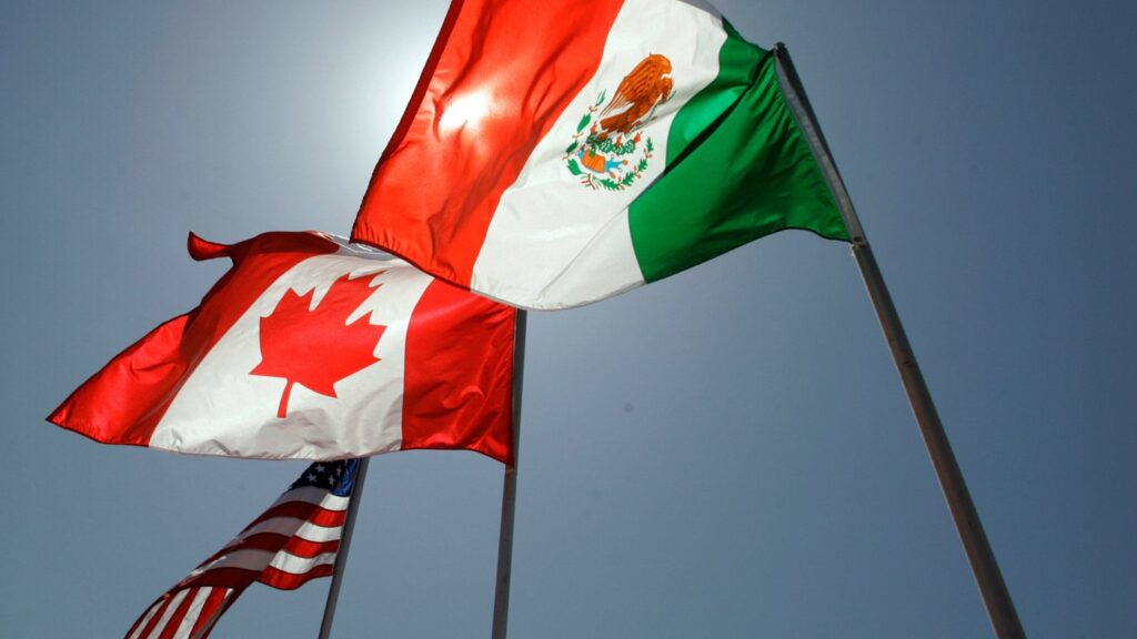 FILE - National flags representing the United States, Canada, and Mexico fly in the breeze in New Orleans where leaders of the North American Free Trade Agreement met on April 21, 2008. (AP Photo/Judi Bottoni, File)